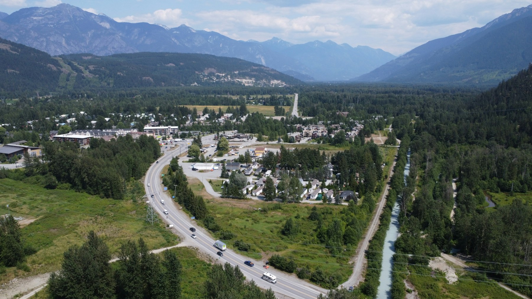 Aerial view of a town in a forested mountain valley