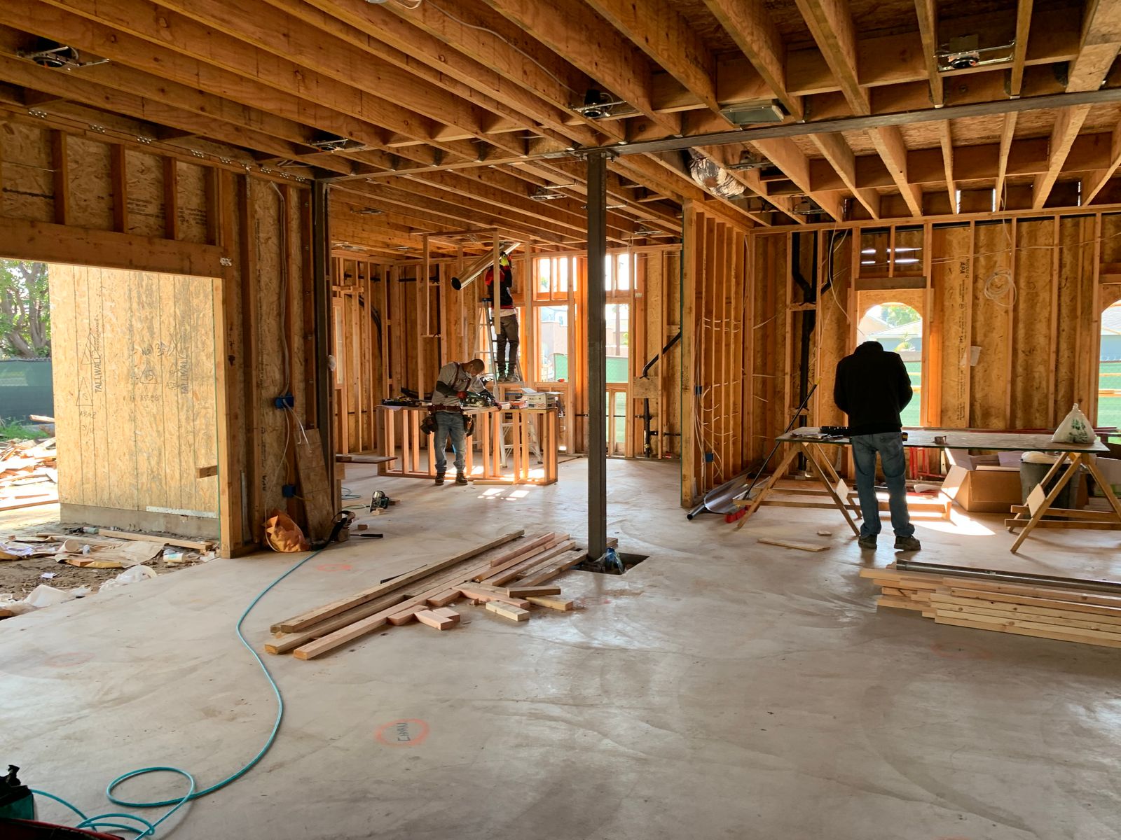 Carpenters working inside a house frame during construction